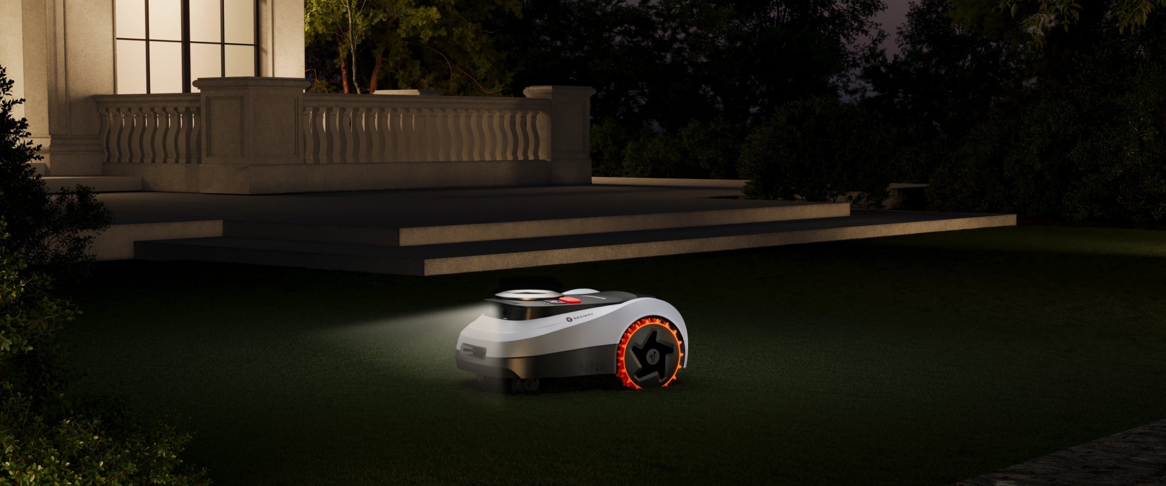 Segway Navimow i110N robot lawn mower mows grass at night.