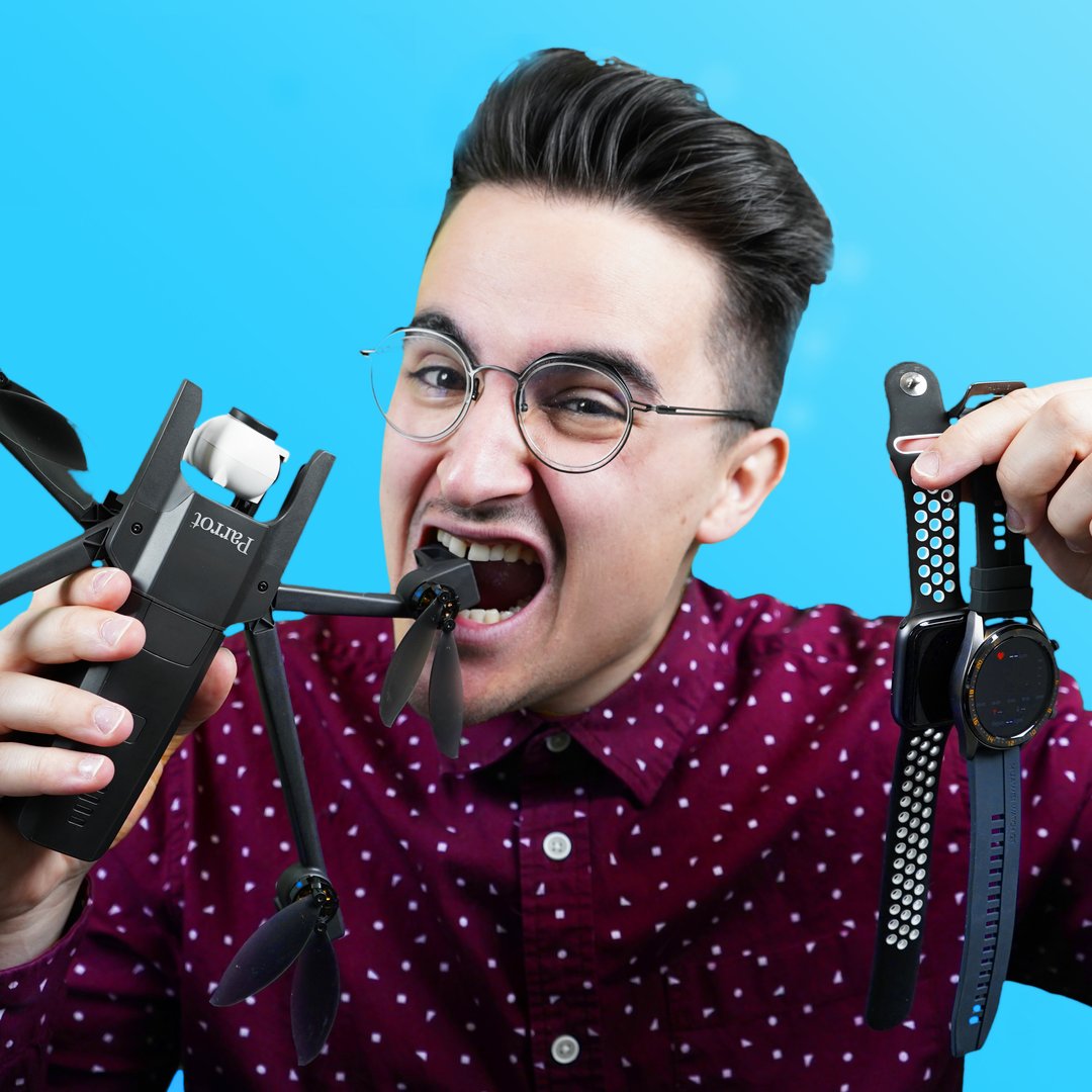Man in glasses biting a drone and holding two watches.
