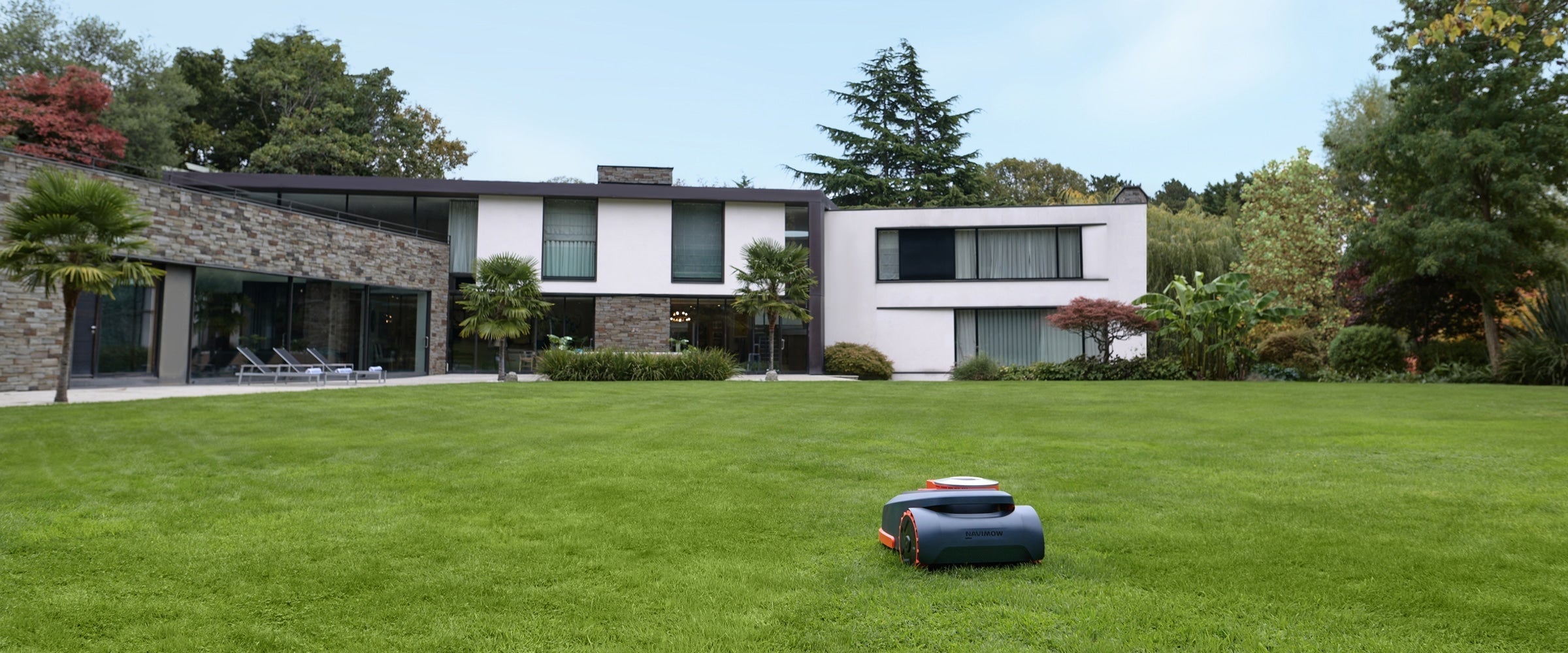 Navimow H series robot lawn mower on a green lawn.