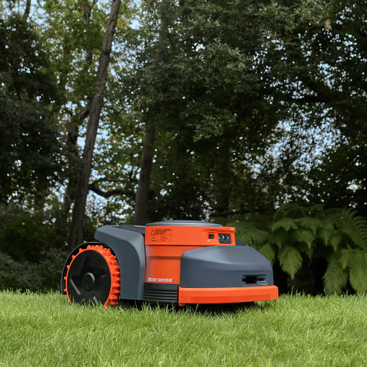 The Navimow i110N robot lawn mower sits on green grass.