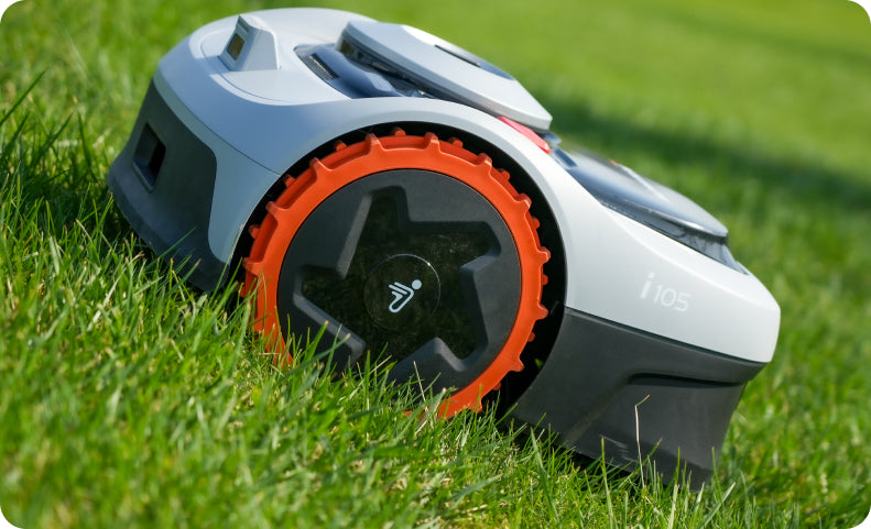 Navimow i105 robot lawn mower sits on the green grass.